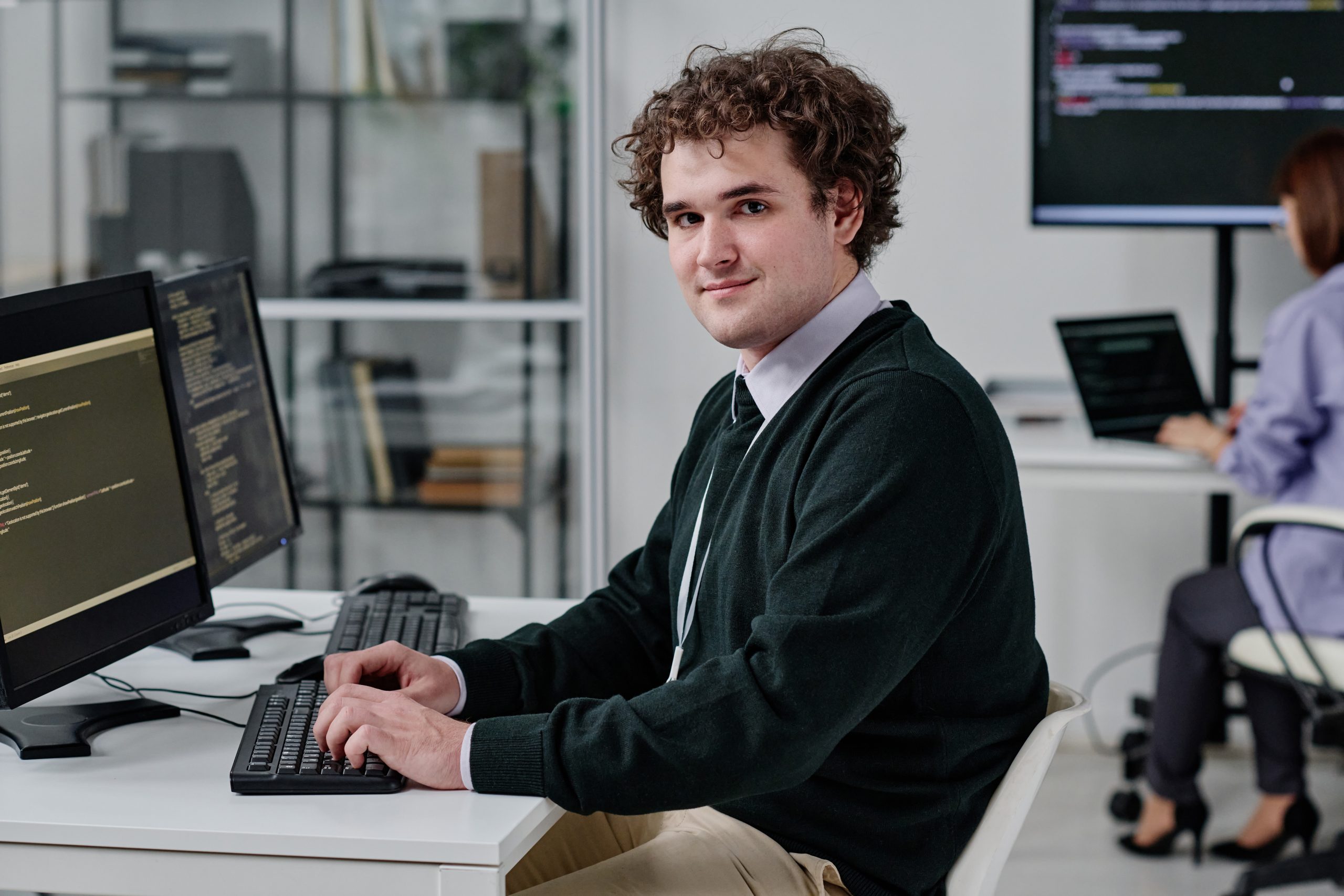IT specialist typing codes on computer
